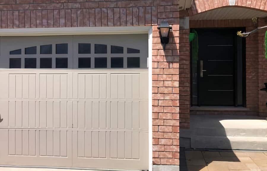 Garage door and front entrance brick house.