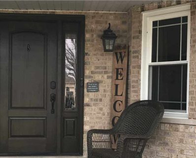 Front porch with chair and welcome sign