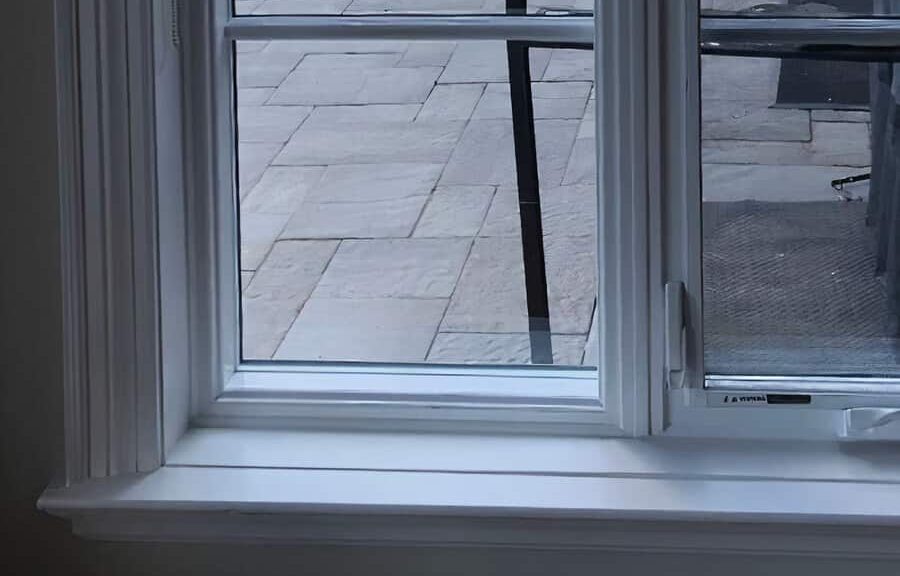 White window frame with outdoor view.
