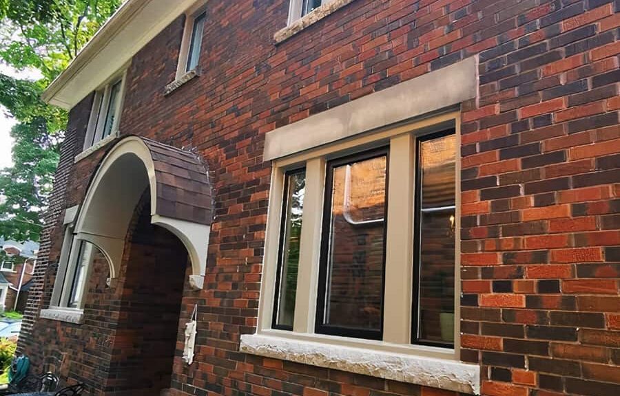 Brick house exterior with arched entry.
