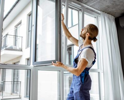 Worker inspecting a window frame